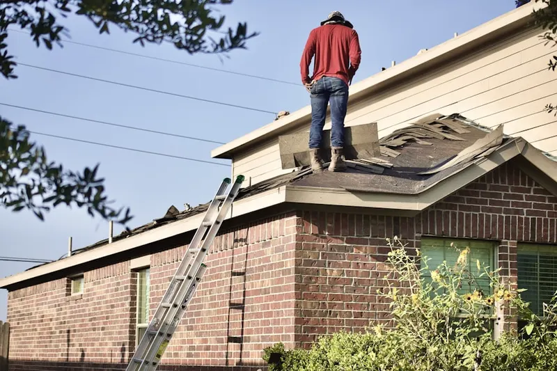 Professional roofer working on a residential roof in Woonsocket
